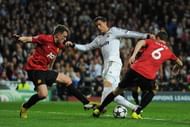 Cristiano Ronaldo of Real Madrid is put under pressure by Jonny Evans and Phil Jones of Manchester United during the UEFA Champions League Round of 16 first leg match between Real Madrid and Manchester United at Estadio Santiago Bernabeu on February 13, 2013 in Madrid, Spain. (Photo by Gonzalo Arroyo Moreno/Getty Images)